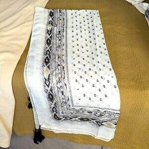 Green label black gold and whitee tasseled in black highlights in gold scarf